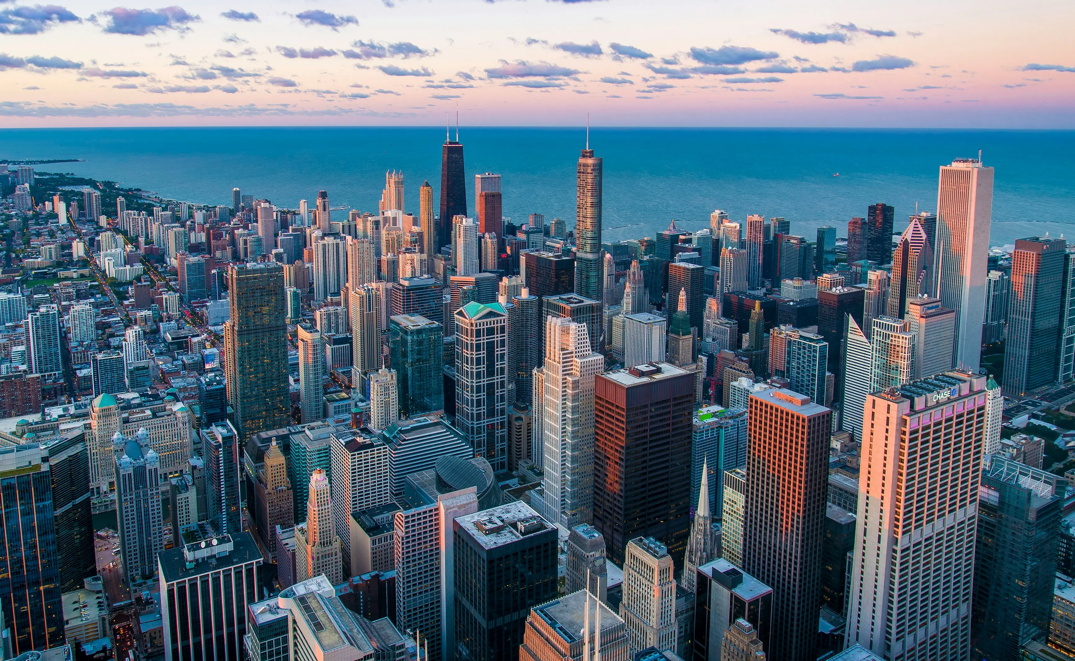 Chicago skyline reflecting on the lake at sunrise